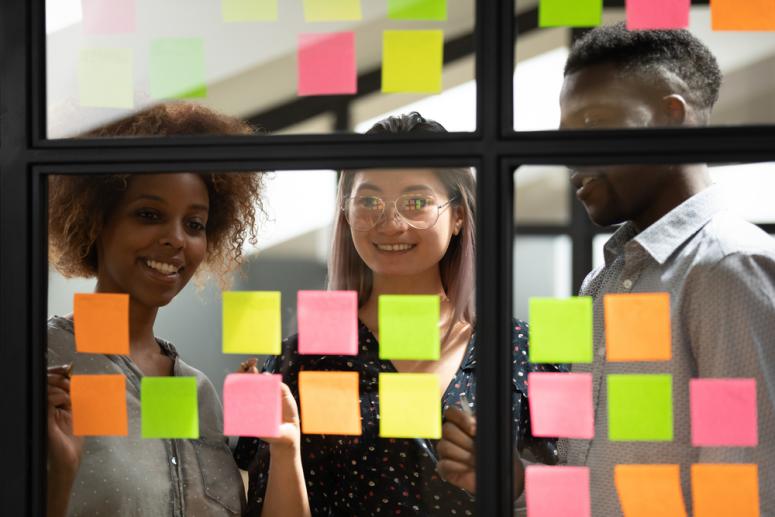 researchers putting sticky notes on a wall