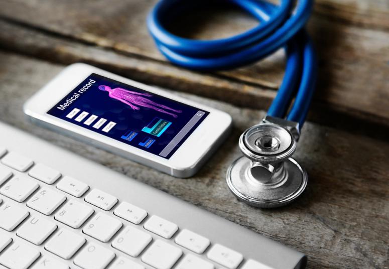 Medical still life and iphone with keyboard on wooden table